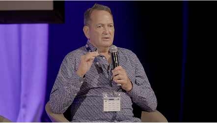 Wayne Johnston (AFL Legend) talking to the audience at Healthia Impact 2024