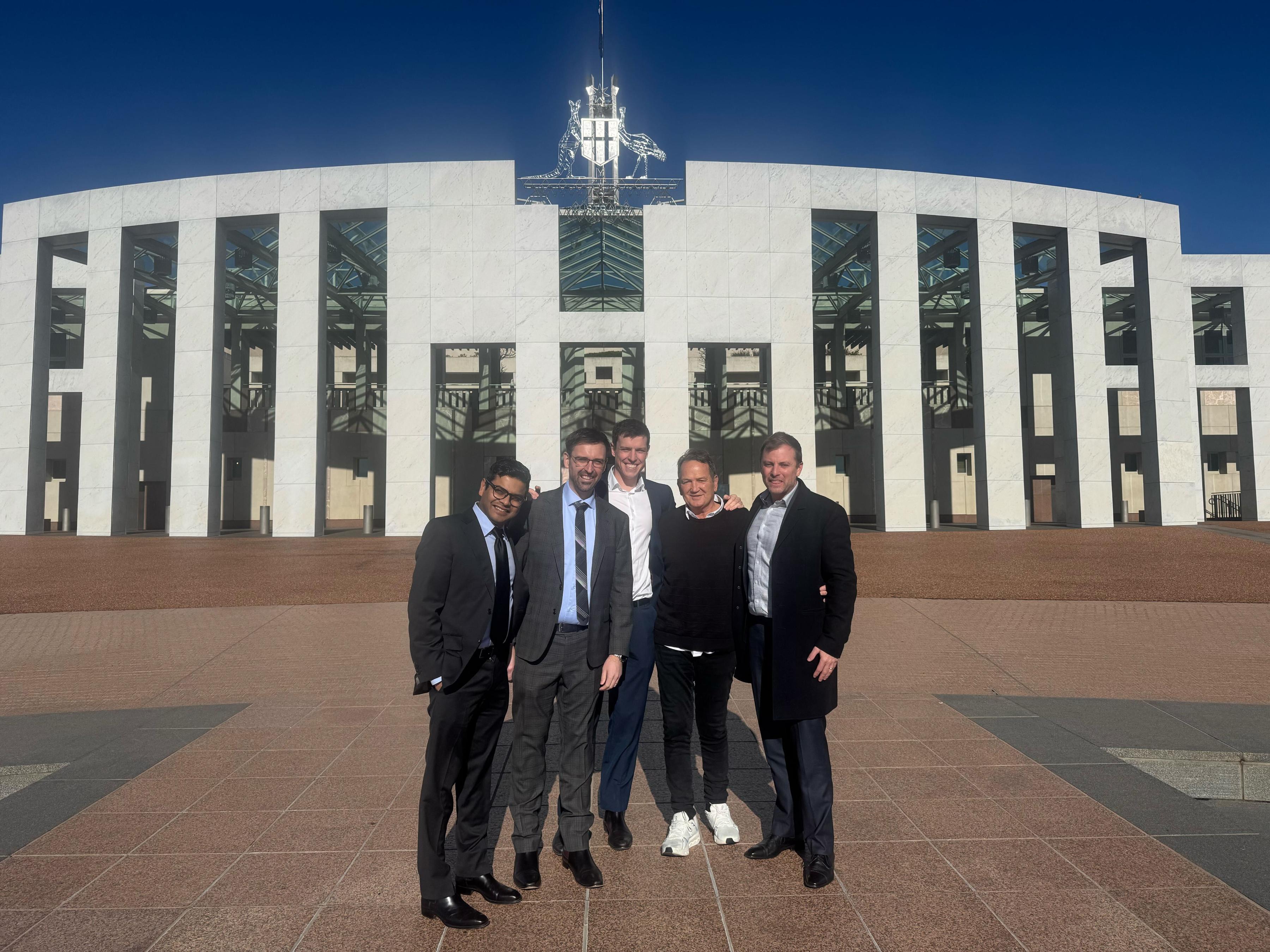The team outside Parliament House.